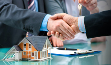 shaking hands over signed documents